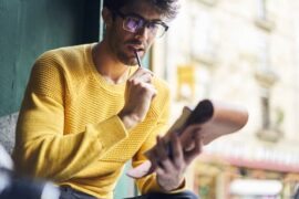 Young man in glasses with notepad