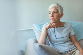 Older woman thinking on couch
