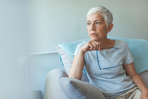 Older woman thinking on couch