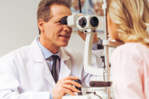 eye doctor performing eye exam on patient